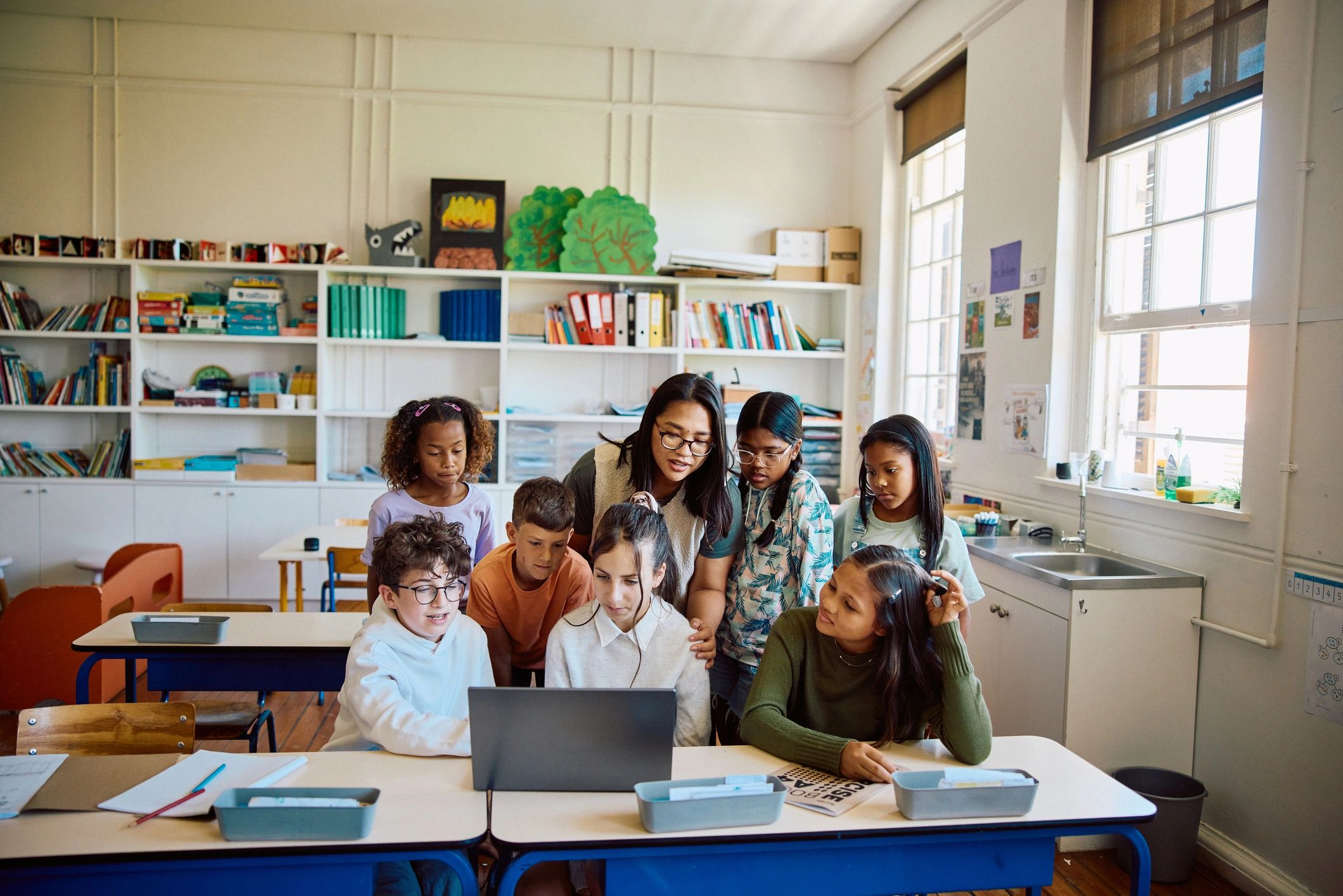 Students learning with a teacher in the classroom